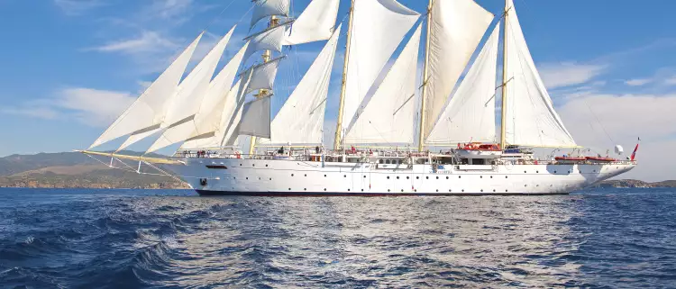 Exterior of the Star Clipper tall ship sailing under a blue sky