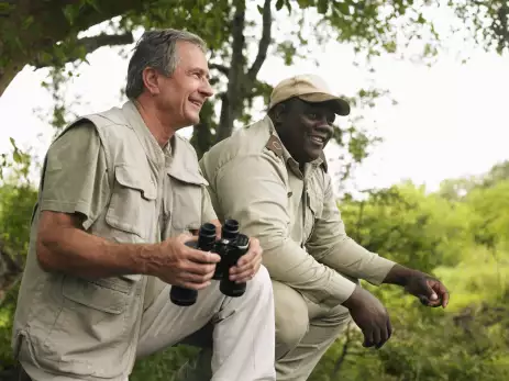 Senior man and Safari guide man smiling together